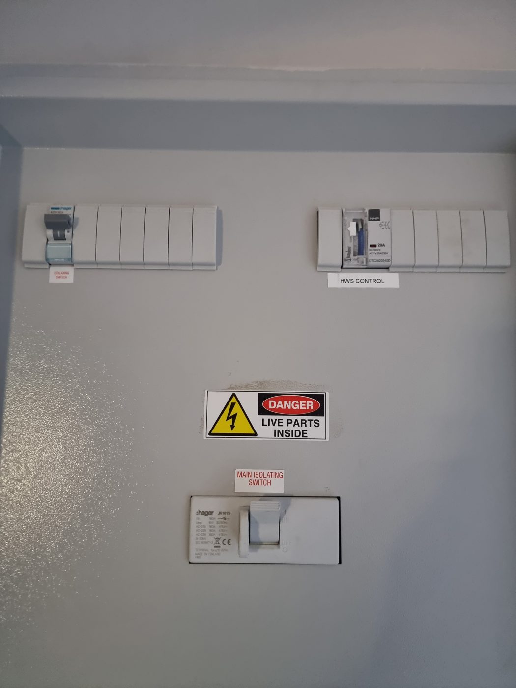 Chassis board with a main isolating switch, a hot water control timer and a danger live parts label