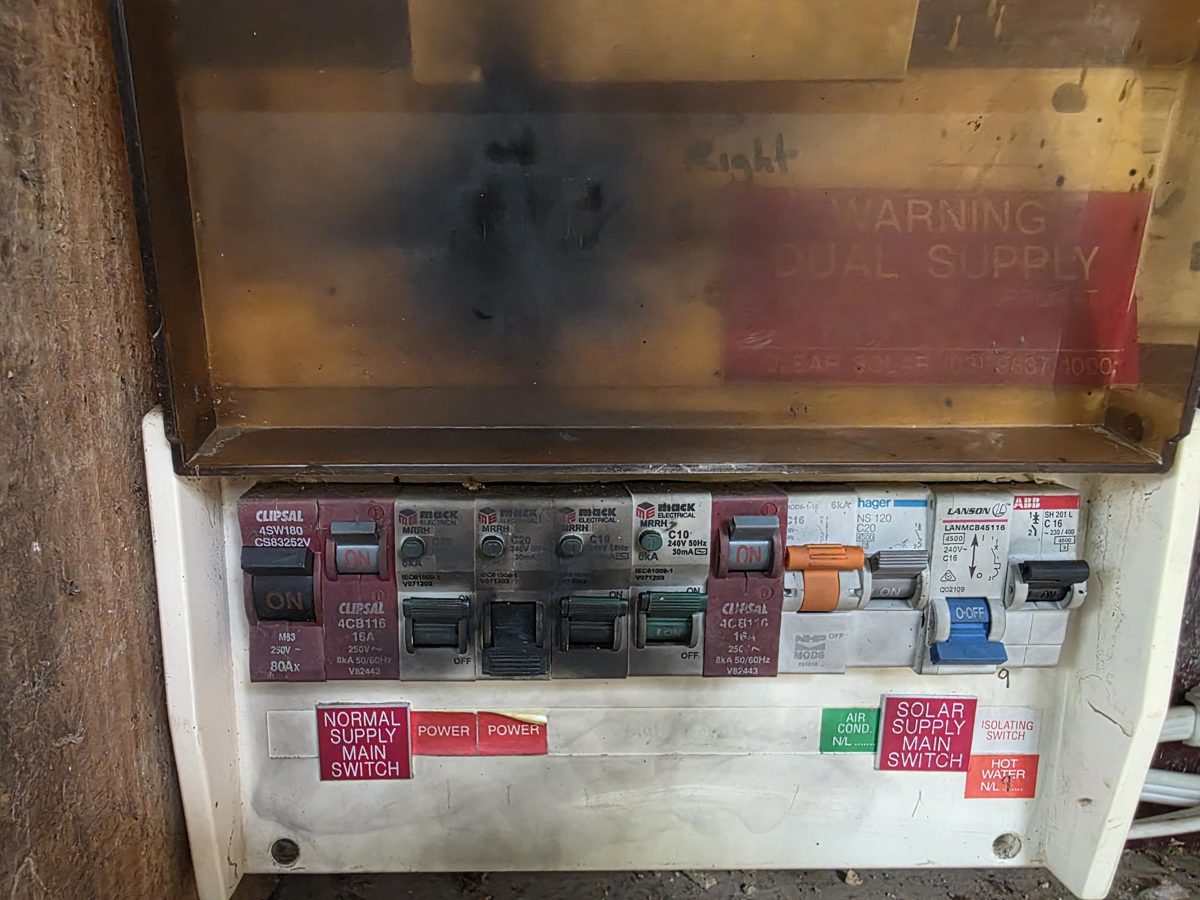 Switchboard with a blackened, heat-damaged cover
